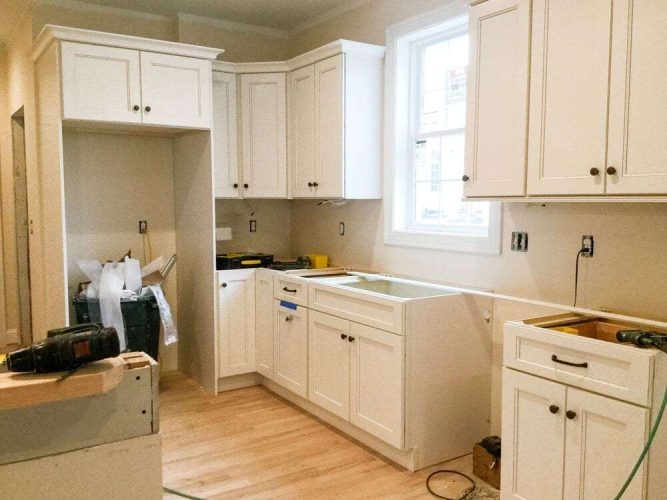 Cabinets being installed without countertops